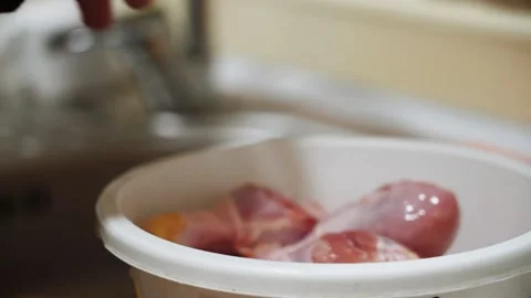 Preparing chicken legs for baking in a sauce in the kitchen Stock Footage 328904543