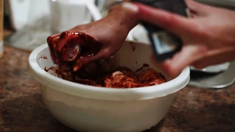Preparing chicken legs for baking in a sauce in the kitchen Stock Footage 328904591
