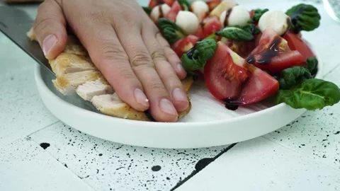 Preparing Chicken Salad with Fresh Tomato and Cheese 動画素材 334280293