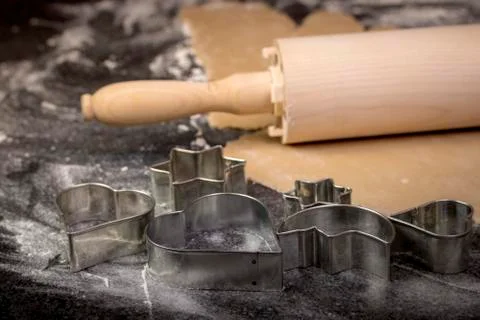 Preparing Christmas cookie dough using a rolling pin to prepare the dough Stock Photos