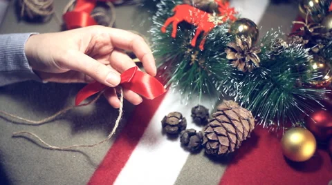 Preparing for Christmas , a master class on making a bow from a tape Stock Footage 57648990
