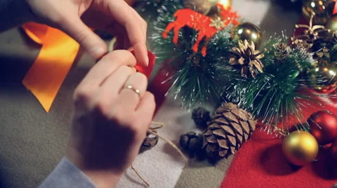 Preparing for Christmas , a master class on making a bow from a tape Stock Footage 57657483