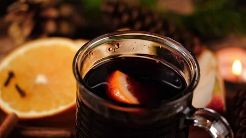 Preparing christmas mulled wine with orange and cinnamon. closeup. Stock Footage 320509910