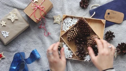 Preparing for Christmas. Women's hands pack a gift. Gift wrapping Stock Footage 143735837