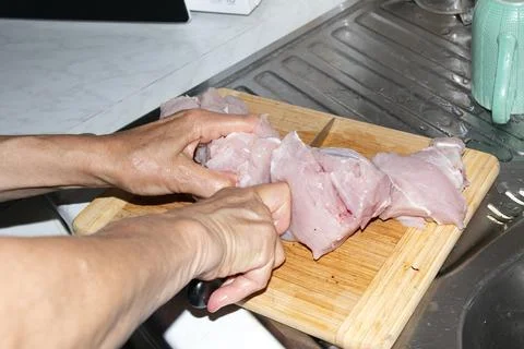 Preparing Chunks of Raw Poultry Meat for Grinding Stock Photos