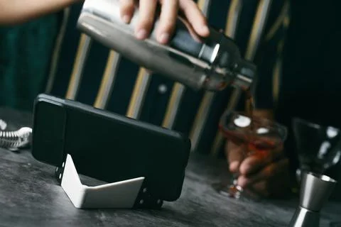 Preparing a cocktail following a tutorial Stock Photos