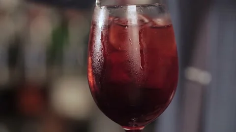 Preparing a cocktail with a slice of lemon. Mix ingredients with a metal spoon. Stock Footage 136217146