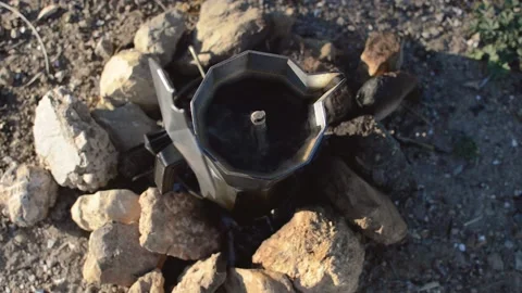 Preparing coffee with bonfire during a camp in nature. Overhead view of firew Stock Footage 133377204