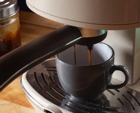 Preparing coffee with a coffee maker filling a cup Stock Photos