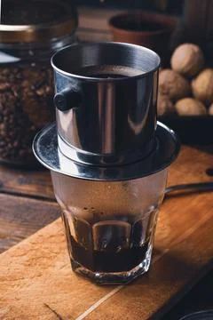 Preparing coffee in Vietnamese drip filter Stock Photos