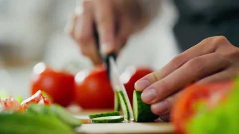 Preparing the concept of healthy food. Close-up of female hands slicing cucu 動画素材 246750909