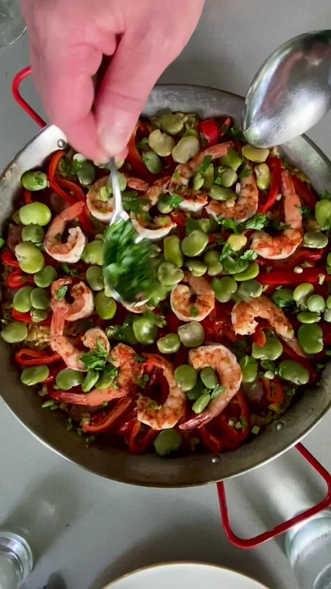 Preparing to cook a pan of shrimp paella Stock Footage 302829239