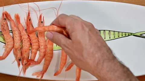 Preparing cooked prawns on a plate Stock Footage 228222817