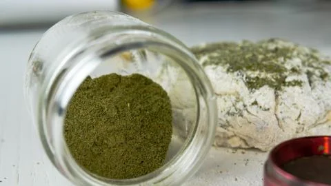 Preparing to cooking hemp cake or bread. Close-up of fresh dough with cannabi Stock Photos