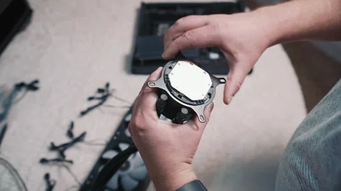 Preparing CPU water block: removing protective film from copper base Stock Footage 324592449