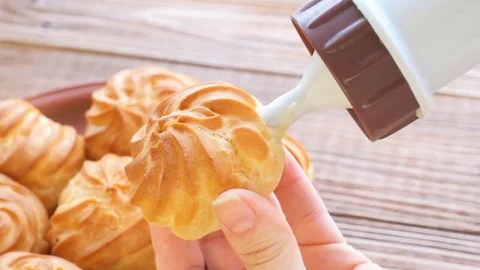 Preparing cream profiteroles. Stock Footage 70131111