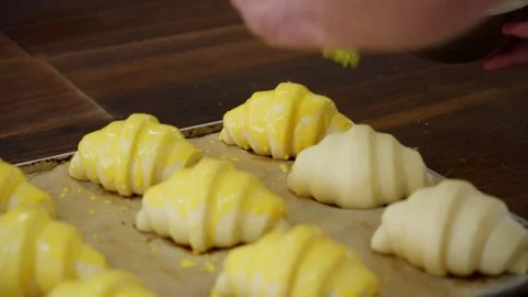 Preparing croissants for baking in the oven. Video stock 313532301