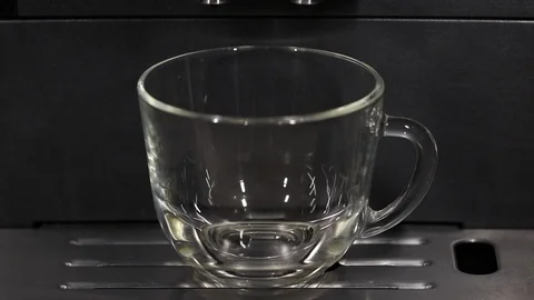 Preparing a cup of strong freshly brewed espresso coffee using a coffee machi Stock Footage 129101971
