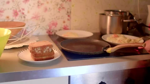 Preparing a delicious cooking sandwich using the stove for heat Stock Footage 318923349