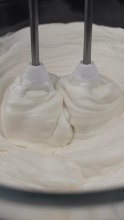 Preparing a delicious dessert curd cream for dessert with a mixer. Stock Footage 281668433