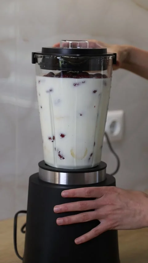 Preparing a delicious fruit milkshake in a blender Stock Footage 337835146