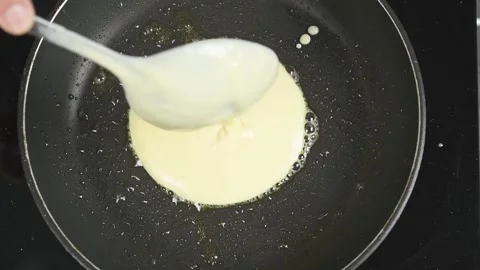 Preparing delicious pancake in a frying pan. Stock Footage 171186176