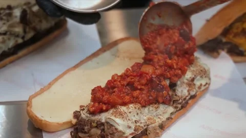 Preparing a Delicious Philly Pizza Steak Sandwich Stock Footage 331636830
