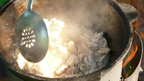 Preparing a delicious pilaf using a Traditional Pot is a culinary experience Stock Footage 283461395