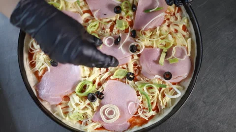Preparing a Delicious Pizza with Various Toppings for a Fantastic Meal Experienc Stock Footage 296633598