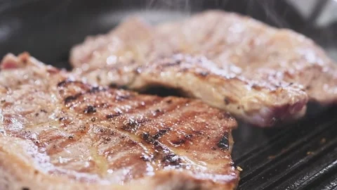 Preparing of delicious pork neck steaks on a grill pan. Stock Footage 150752239