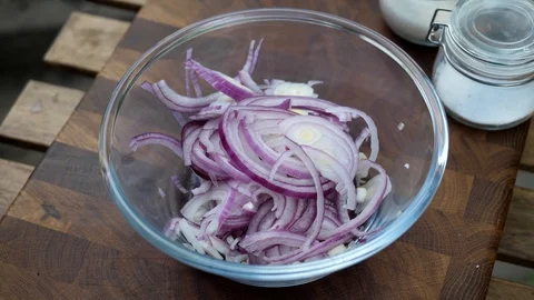 Preparing a delicious side dish of vegetables and herbs for a pork barbecue Stock Footage 128919475