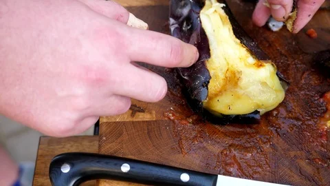 Preparing a delicious side dish of vegetables and herbs for a pork barbecue Stock Footage 128920225