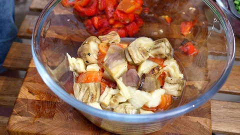 Preparing a delicious side dish of vegetables and herbs for a pork barbecue Stock Footage 128921092