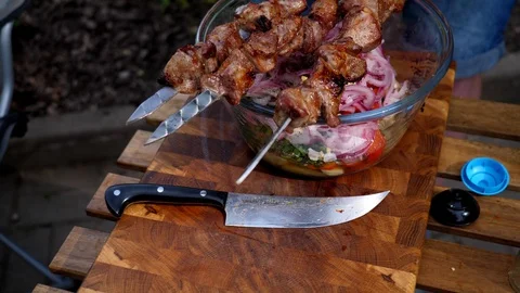 Preparing a delicious side dish of vegetables and herbs for a pork barbecue Stock Footage 128921686