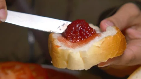 Preparing a delicious slice of bread with jam 스톡 동영상 302859313