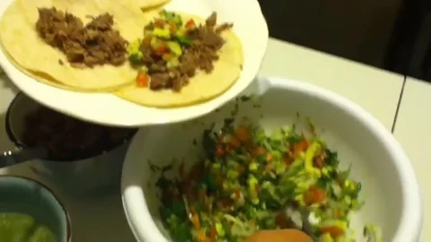 Preparing delicious tacos with fresh toppings at home 스톡 동영상 320198786