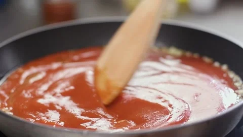 Preparing of delicious tomato sauce in a pan. Stock Footage 154369999