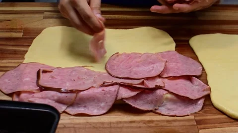 Preparing Delicious Traditional Ham Bread with Layered Dough Vídeo Stock 332621954