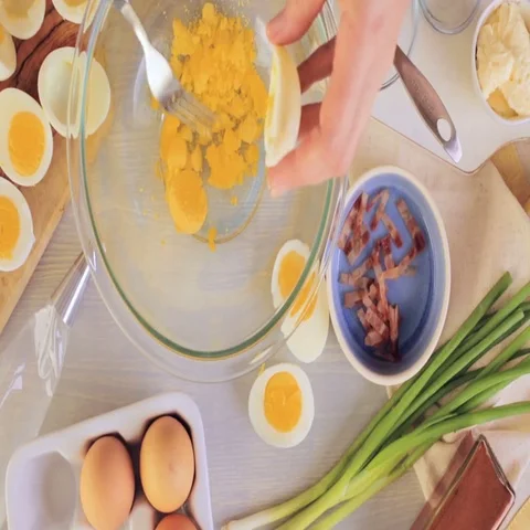 Preparing deviled eggs with organic eggs for appetizer. Step by step recipe. Video stock 69728142