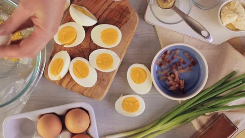 Preparing deviled eggs with organic eggs for appetizer. Step by step recipe. Video stock 69728255