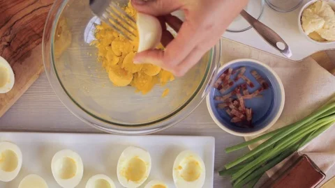 Preparing deviled eggs with organic eggs for appetizer. Step by step recipe. Video stock 69728265