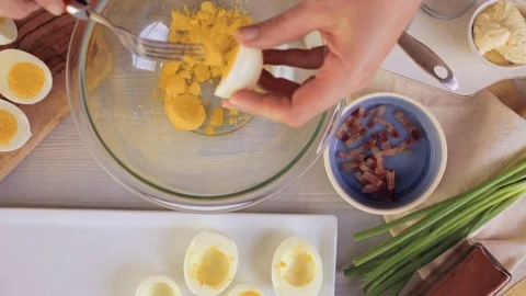 Preparing deviled eggs with organic eggs for appetizer. Step by step recipe. Video stock 69728403