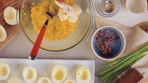 Preparing deviled eggs with organic eggs for appetizer. Step by step recipe. Video stock 69728935