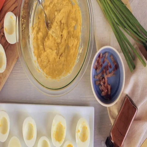 Preparing deviled eggs with organic eggs for appetizer. Step by step recipe. Video stock 69729424