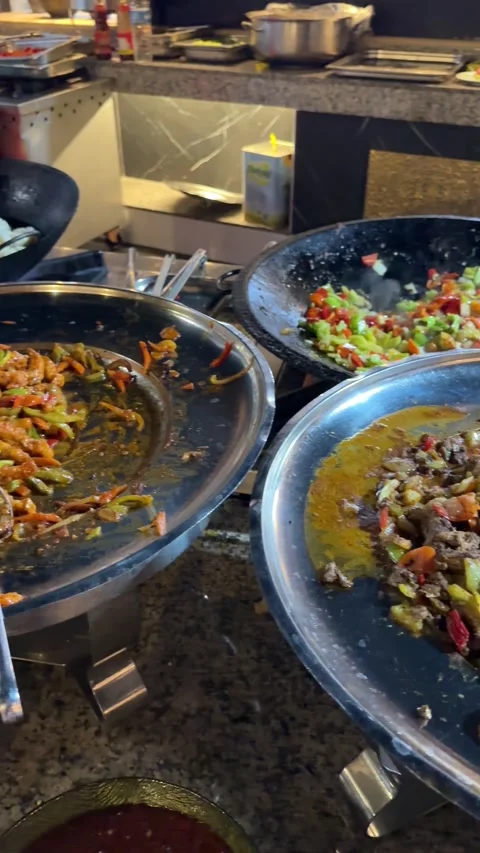 Preparing dishes for a buffet at a resort restaurant, with a variety of fresh Stock Footage 303360471