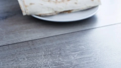 Preparing doner kebab in the kitchen. Cutting in half the finished doner keba 스톡 동영상 106196477