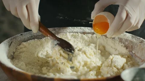 Preparing the dough, adding egg Stock Footage 138192748