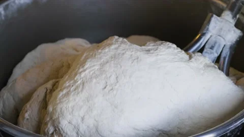 Preparing dough with a dough kneading machine. Industrial dough machine. Stock Footage 234914327