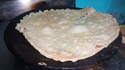Preparing dough for making a popular dish known as roti. Stock Footage 143395566