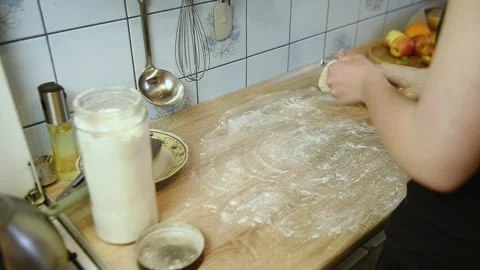 Preparing dough piece for rolling out on kitchen table Stock Footage 340078116